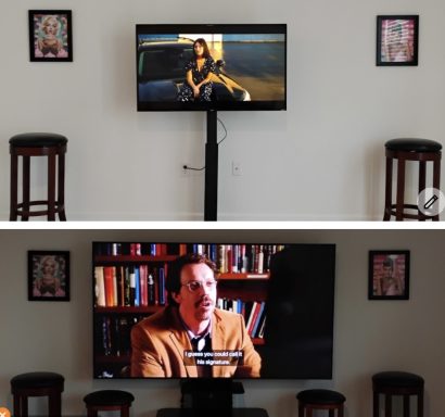 Two TVs mounted on a wall, one showing a woman and the other a man in front of bookshelves.